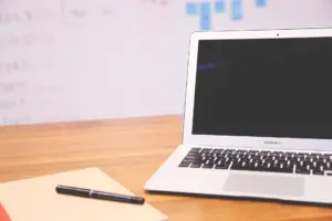 Notebook and laptop on a desk for startup planning